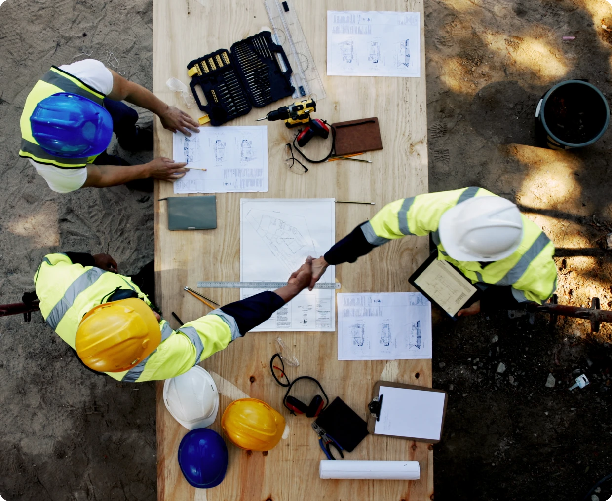 Engineers discussing project plans on table