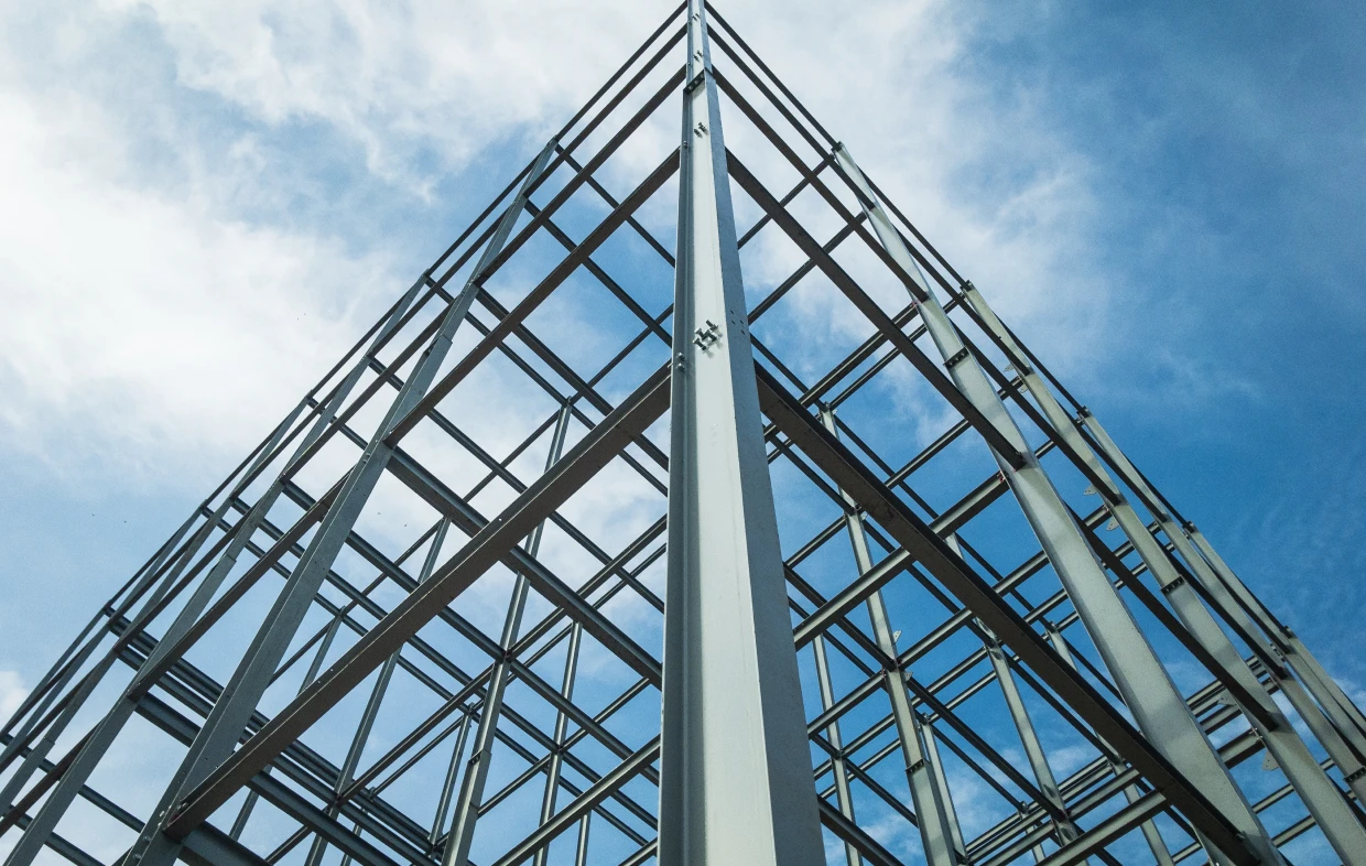 Modern metal structure under clouds
