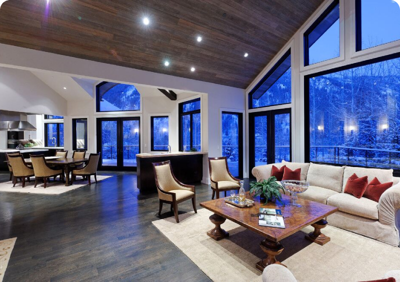 Spacious modern living room with large windows and cozy seating.